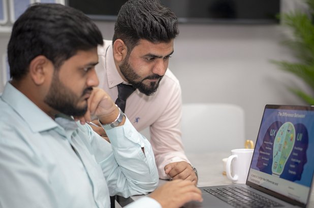 Emirates Way Delivery Services media and marketing team members while discussing rider app designs