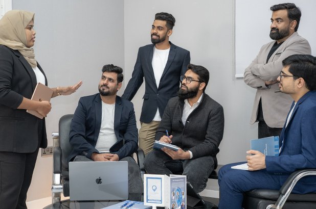 Emirates Way Delivery Services media and marketing team member explaining the marketing strategy to team