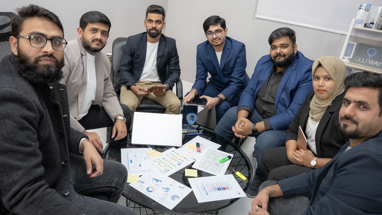 Emirates Way Delivery Services media and marketing team facing Camera while working