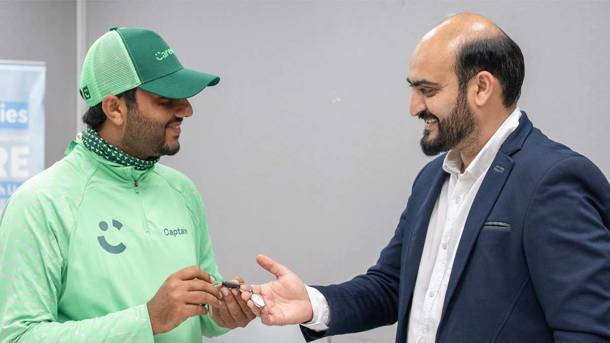 Emirates Way Delivery Services Operation team member giving motorbike Key to rider