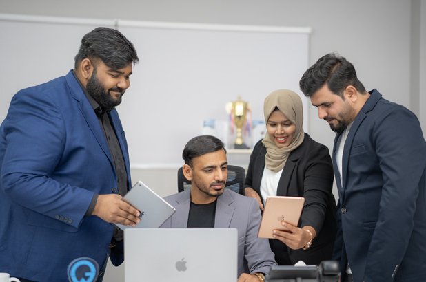 Emirates Way Delivery Services media and marketing team members showing happiness on achievement of milestone