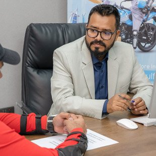 Emirates Way Delivery Services Operations Team Member Listening to Rider Issues in Office