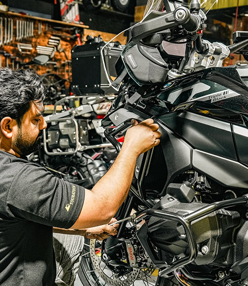 Emirates Way Delivery Services auto garage mechanic making bike ready to go for rider