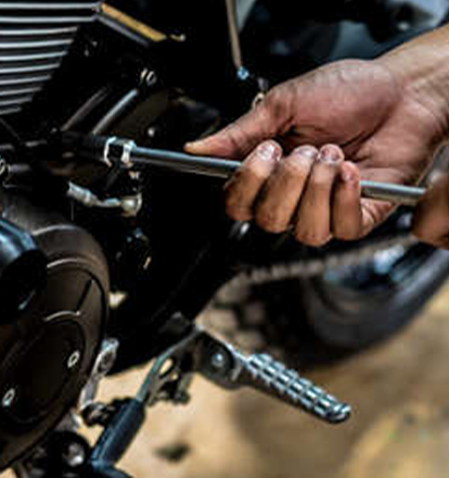 Emirates Way Delivery Services auto garage mechanic while opening engine with spanner